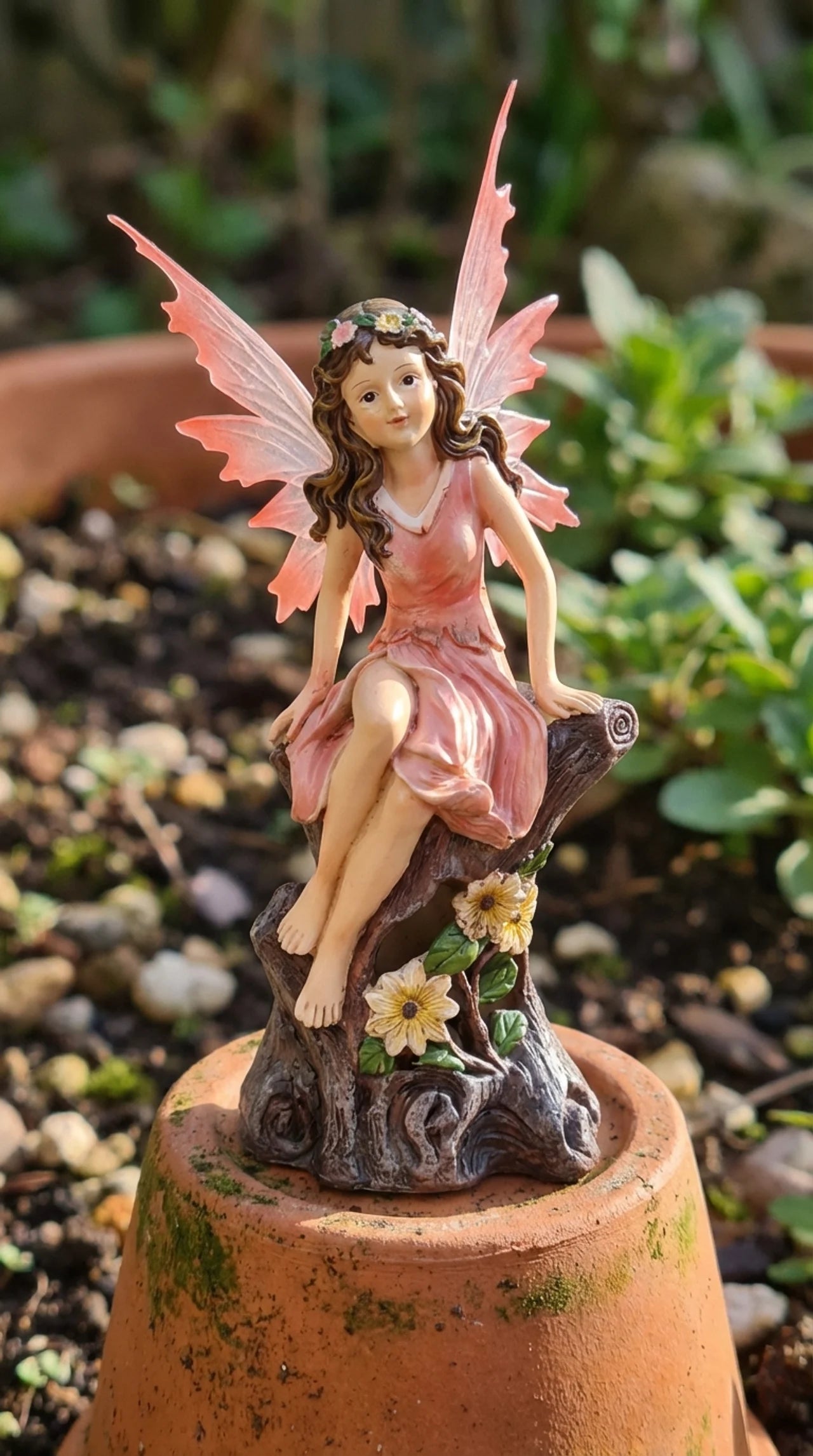 Hand-painted resin fairy garden statue in coral pink dress seated on tree stump with sunflowers, 14.5 inches tall