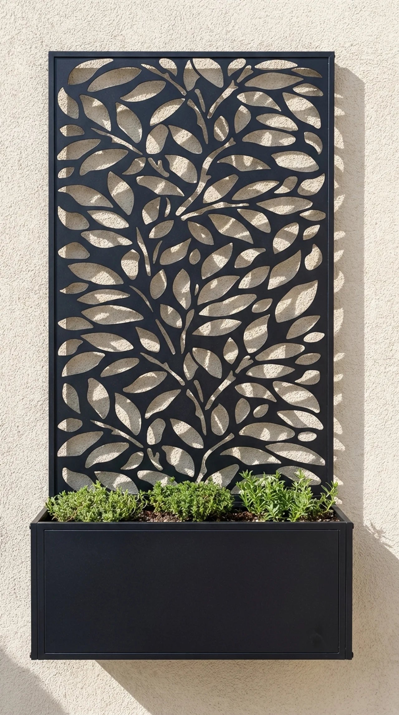 Metal leaf screen garden planter freestanding on patio, black powder coated finish, Form and Foliage collection.