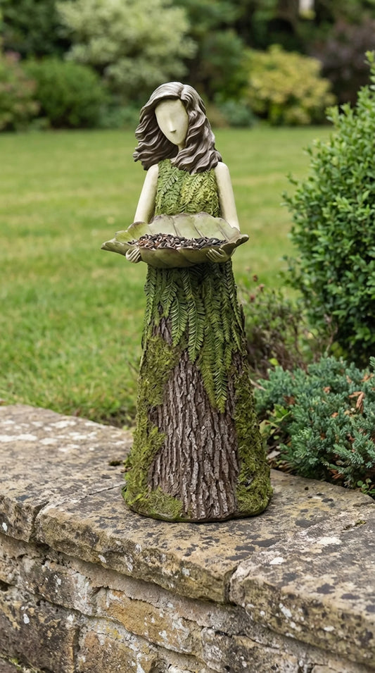 Hand-finished resin garden sculpture of female figure in fern leaf dress holding leaf bird feeder bowl, 30cm tall