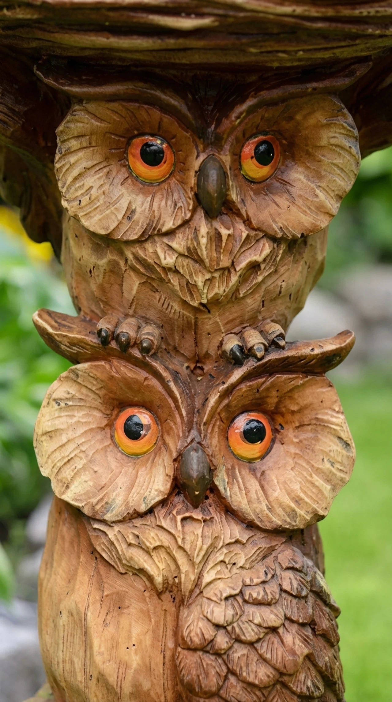 Close-up of Hoot and Hollow owl ornament showing woodgrain bark texture detail, two owl faces, and woven nest bowl at top
