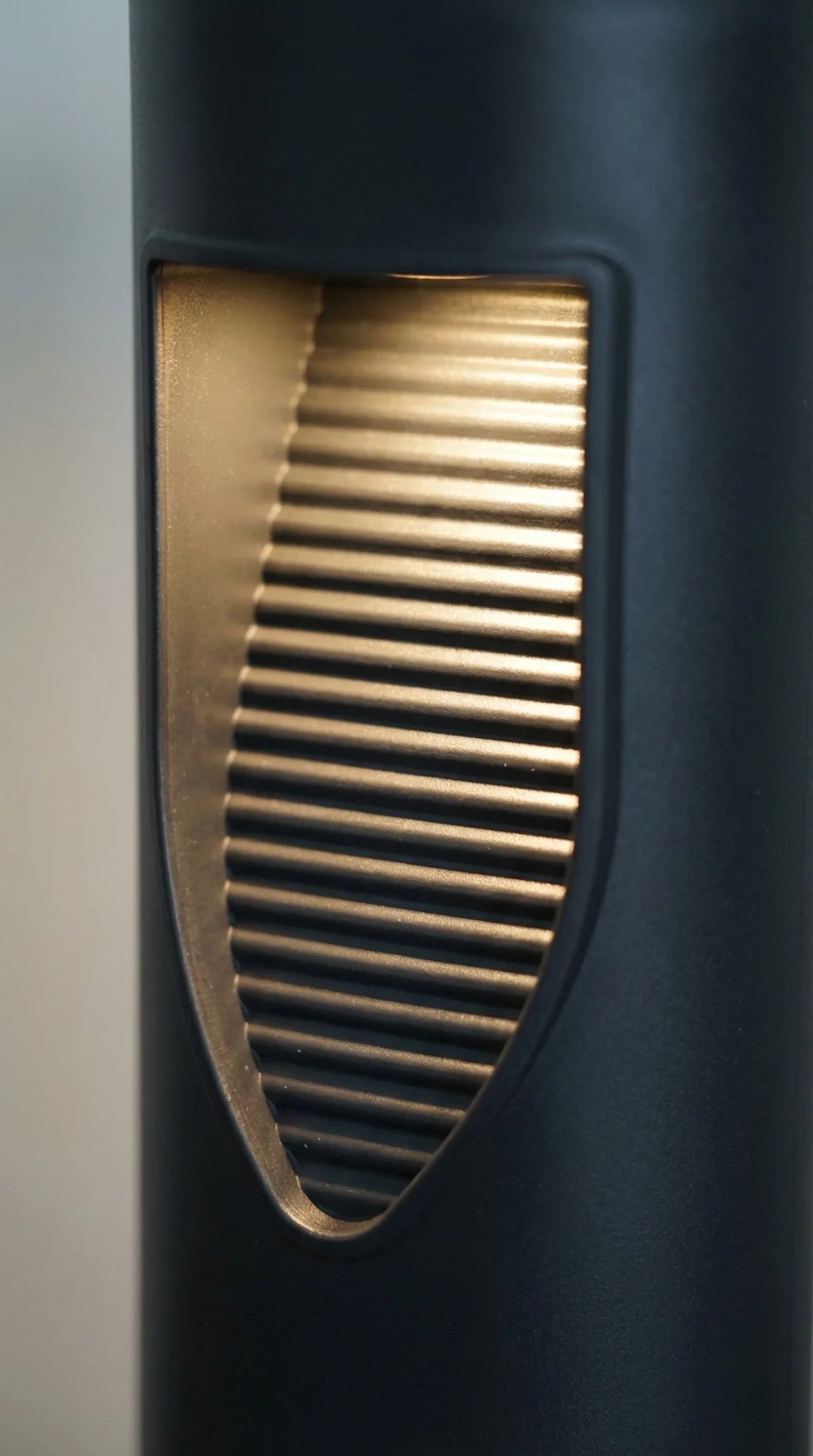 Close-up of a black solar light with a ribbed design