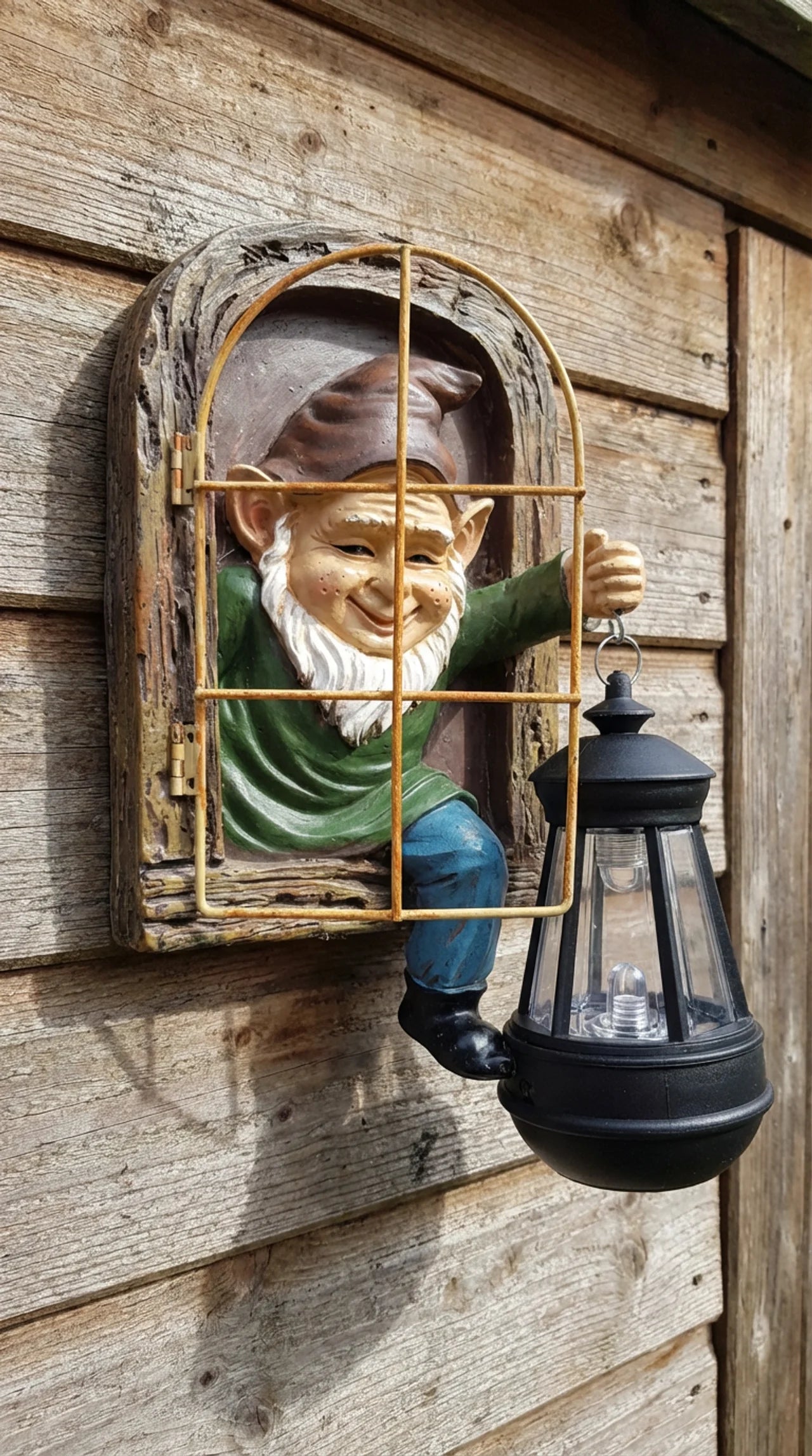 Close-up of hand-painted gnome face and aged barred window detail on solar wall ornament